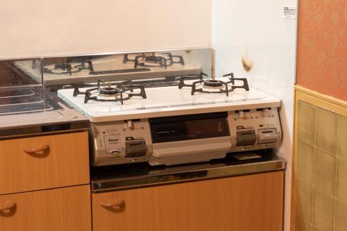 a kitchen with a stove top oven in a kitchen at Prosper 5th bldg 501 in Nagoya