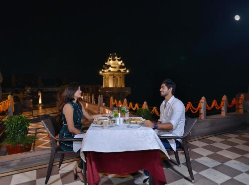 a man and a woman sitting at a table at BrijRama Palace, Varanasi - By the Ganges in Varanasi