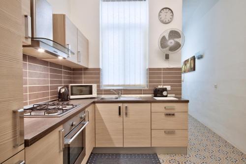 a kitchen with a sink and a stove top oven at Valletta Apartments 19 in Valletta