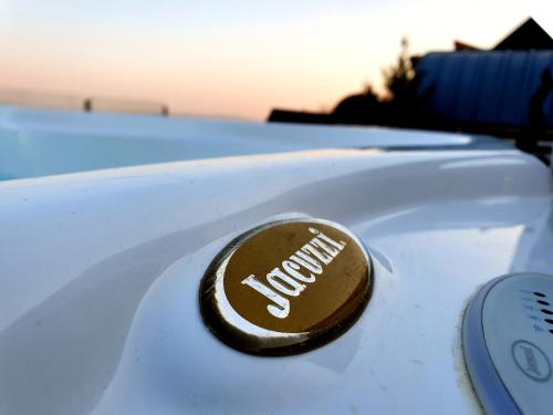 a close up of a nissan logo on the hood of a car at Bagoly Wellness Apartman in Pécs