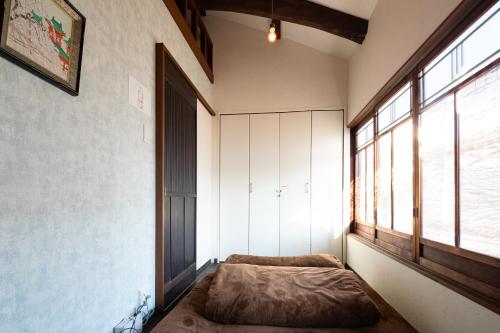 a bed in a room with a window at JISHO-AN in Kyoto
