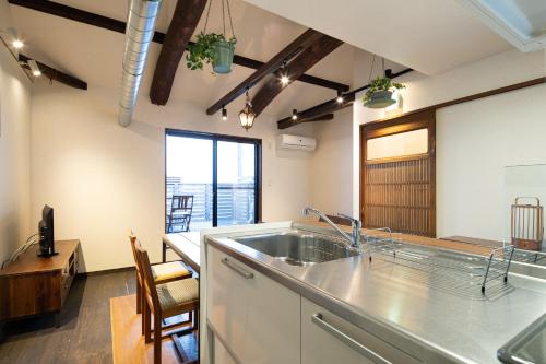 a kitchen with a sink and a counter top at JISHO-AN in Kyoto