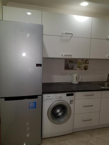 a kitchen with a washing machine and a sink at Apartment in Ternopilʼ