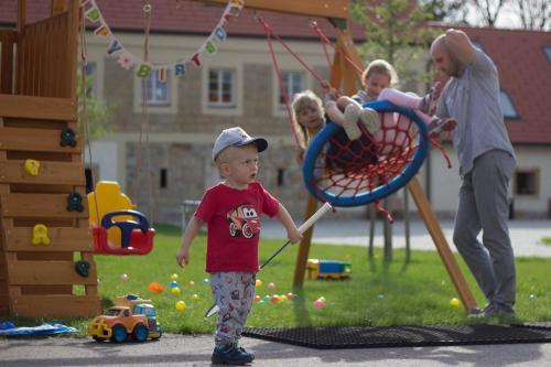 a young boy is playing in a playground at tvrz KRASSA in Osečná
