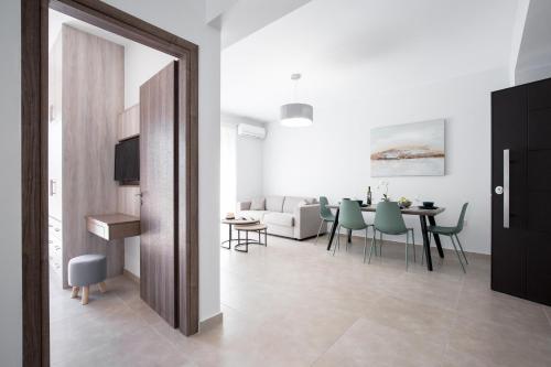 a living room and dining room with a table and chairs at Casa Ntore Luxury Apartments in Chania Town