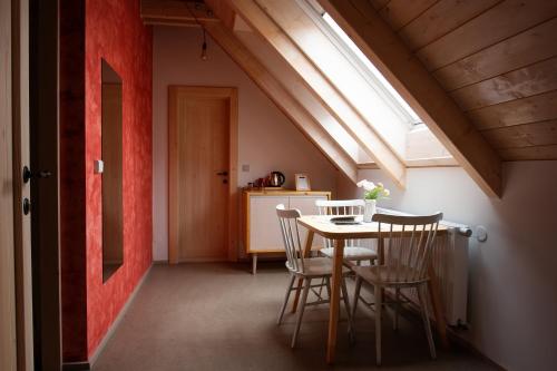 a dining room with a table and chairs and a window at tvrz KRASSA in Osečná