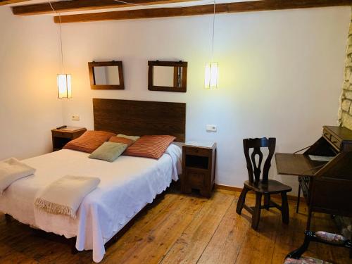 a bedroom with a large bed and a piano at Argonz Etxea in Urzainqui