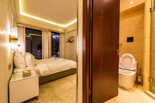 a bathroom with a bed and a toilet in a room at AC Residence - Behind Cititel Hotel in Kota Kinabalu