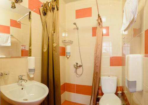 a bathroom with a sink and a toilet and a shower at Hotel 12 in Kharkiv