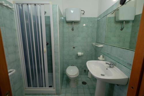 a bathroom with a toilet and a sink at Macinelle in Marina di Camerota