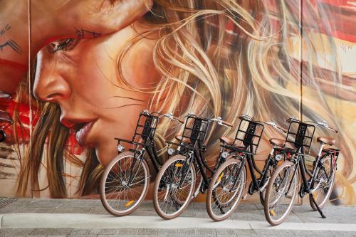 a group of bikes parked in front of a mural at The Adnate Perth - Art Series in Perth