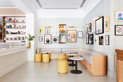 a restaurant with yellow stools in a room at The Adnate Perth - Art Series in Perth