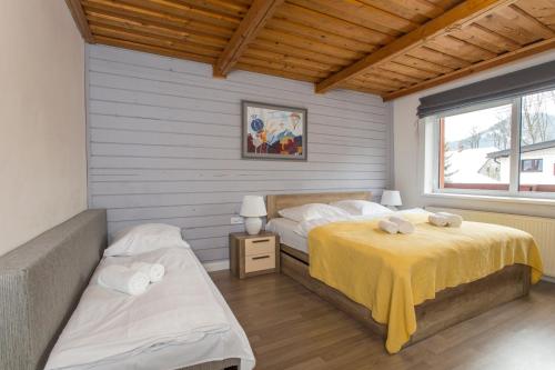1 dormitorio con 2 camas y manta amarilla en Guesthouse YeS in Bodice, en Bodice