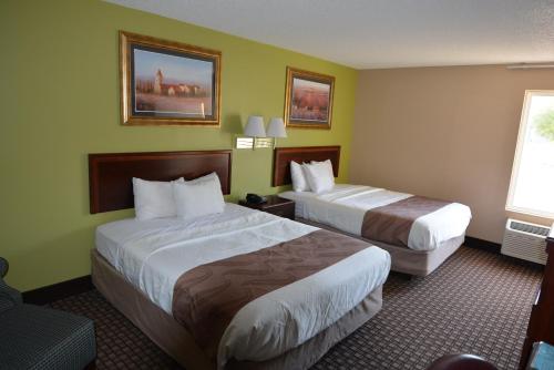 a hotel room with two beds and a window at Jameson Inn and Suites Hazelhurst in Hazlehurst