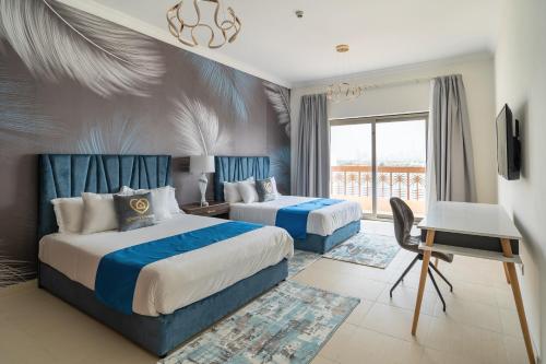 una camera d'albergo con due letti e un balcone di GLOBALSTAY at Palm Jumeirah Beachfront Paradise with Pool and Gym a Dubai