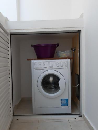 a washing machine in a kitchen with a bowl on top at Roussa's View Apartments in Sitia