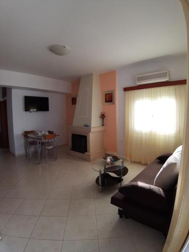a living room with a couch and a table at Roussa's View Apartments in Sitia