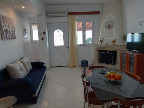 a living room with a blue couch and a table at Roussa's View Apartments in Sitia
