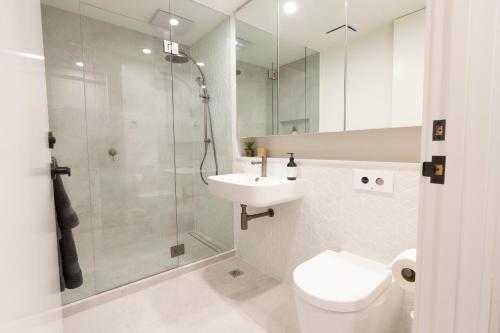 a bathroom with a toilet and a sink and a shower at Mt Buller Chalet Hotel & Suites in Mount Buller