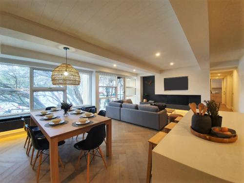 a large living room with a table and a couch at Mt Buller Chalet Hotel & Suites in Mount Buller