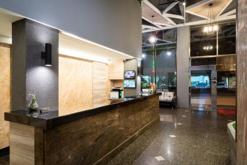 a lobby with a reception desk in a building at Yadi Hotel in Puli