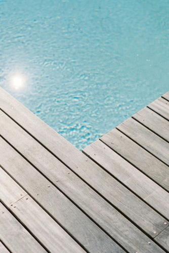 a wooden pier next to a pool of water at Byron Springs in Byron Bay