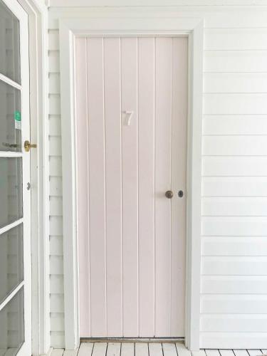 a door leading into a room with white walls at Byron Springs in Byron Bay