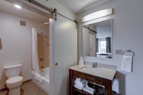 a bathroom with a toilet and a sink and a shower at Inn at Rohnert Park in Rohnert Park