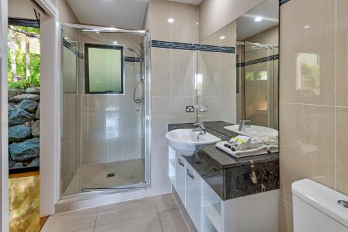a bathroom with a sink and a shower at Pinnacle Apartments on Hamilton Island by HIHA in Hamilton Island