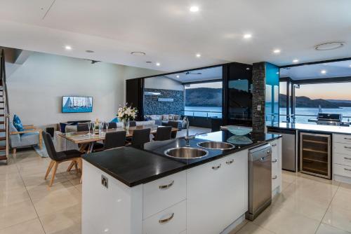a kitchen and dining room with a view of the ocean at Edge Apartments on Hamilton Island by HIHA in Hamilton Island