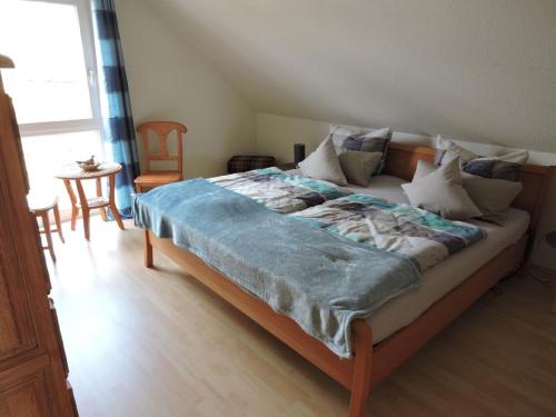 a bedroom with a bed with a blue blanket on it at Ferienhaus - Haus Winterberg in Winterberg