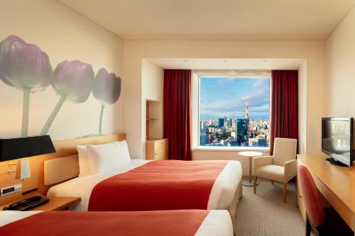 a hotel room with two beds and a window at Park Hotel Tokyo in Tokyo