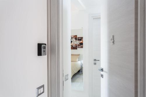 a door leading into a room with a bed at Nùe Rooms in Cagliari