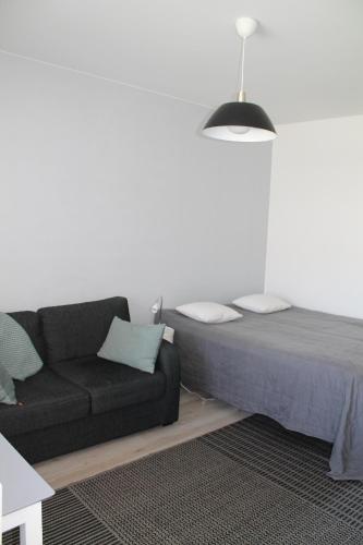 a living room with a bed and a couch at Valtakatu 2 in Pori