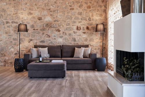 a living room with a couch and a fireplace at Anar Villas Rhodes in Koskinou