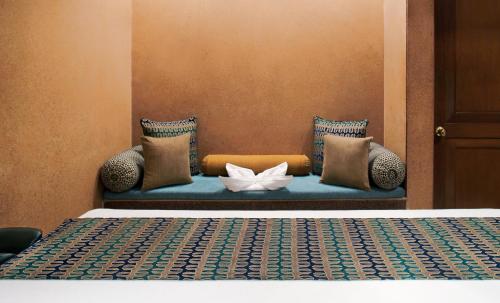 a bed with a white flower on a blue couch at Taj Mahal Lucknow in Lucknow