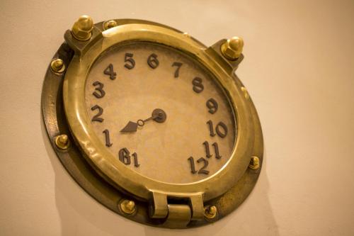 a gold clock hanging on a wall at Hotel Monterey Kobe in Kobe