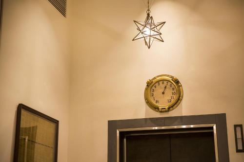 a clock on a wall with a star above a door at Hotel Monterey Kobe in Kobe