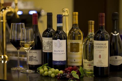 a group of wine bottles and glasses on a counter at Hotel Monterey Kobe in Kobe