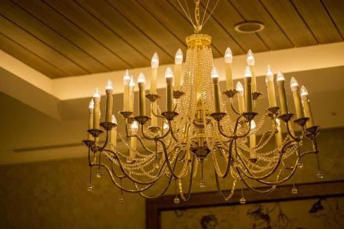 a chandelier is hanging from a ceiling at Hotel Monterey Kobe in Kobe