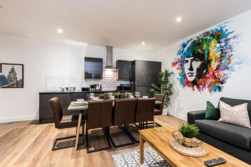 a living room with a dining table and a kitchen at SGT Peppers Mathew Street Apartments By Happy Days in Liverpool