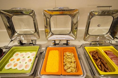 four containers of different types of food sitting on a counter at Hotel Monterey Kobe in Kobe