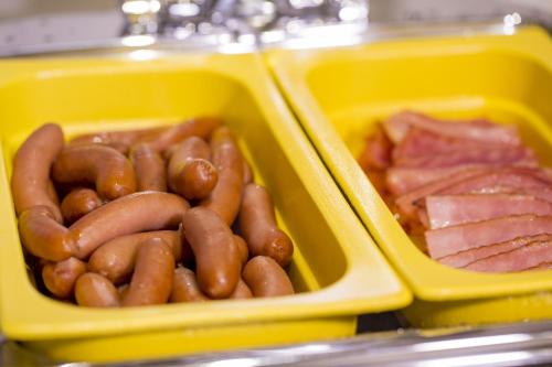 two plastic containers filled with hot dogs and meat at Hotel Monterey Kobe in Kobe