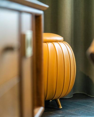 an orange stool sitting next to a table at The Collector in The Hague