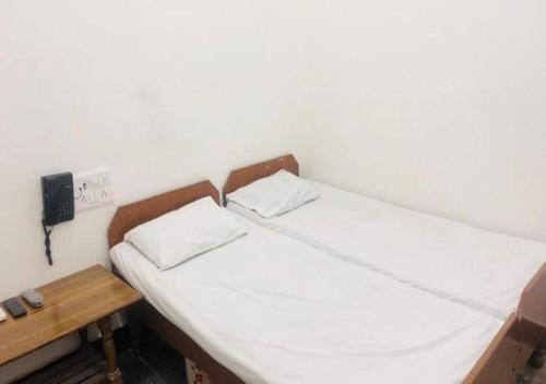 Säng eller sängar i ett rum på Hotel Chandan