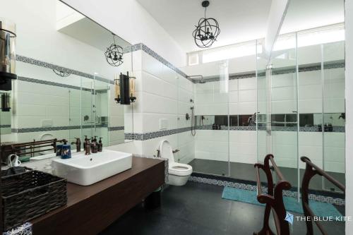 a bathroom with a sink and a toilet at La Maroma 3 BHK Splendid Villas in Anjuna - Pvt Pool- Garden & Caretaker in Vagator