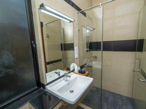 a bathroom with a sink and a shower at Spring Villas Kandy in Kandy