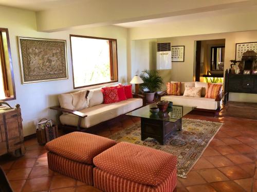 a living room with two couches and a table at Ataalaya Farmhouse in Batangas City