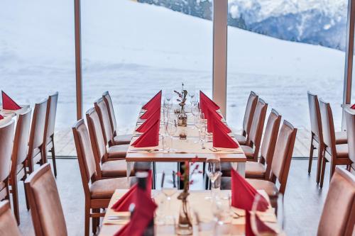a table with red napkins and chairs in a room at Lizum 1600 | Kompetenzzentrum Snowsport Tirol in Axamer Lizum