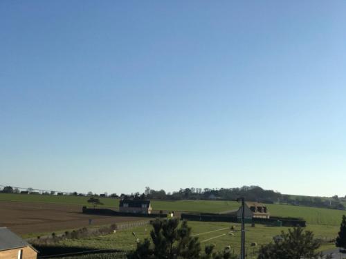 a view of a field with trees and houses at La Villa Port Winston - Face Mer B&B in Saint-Côme-de-Fresné